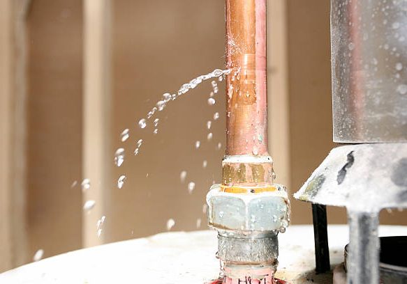Water leaking out of a pipe on top of a water heater. Water leaking out of a pipe on top of a water heater.