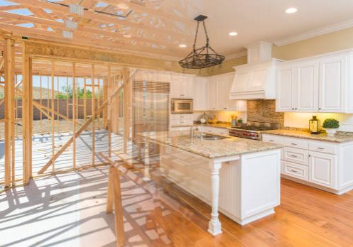 House Construction Framing Gradating Into Finished Kitchen Build. House Construction Framing Gradating Into Finished Kitchen Build.