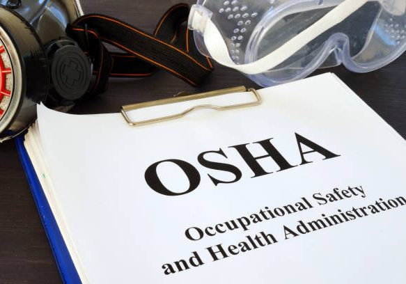 Pile of documents with Occupational Safety and Health Administration OSHA. Pile of documents with Occupational Safety and Health Administration OSHA.